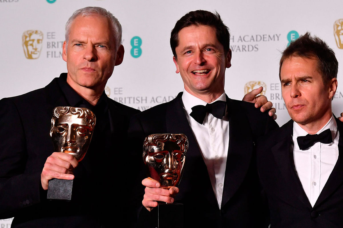 British-Irish filmmaker Martin McDonagh (L), producer Peter Czernin (C) hold their awards for Best Film with US actor Sam Rockwell for the film `Three Billboards Outside Ebbing Missouri` at the BAFTA British Academy Film Awards at the Royal Albert Hall in London on 18 February, 2018. Photo: AFP