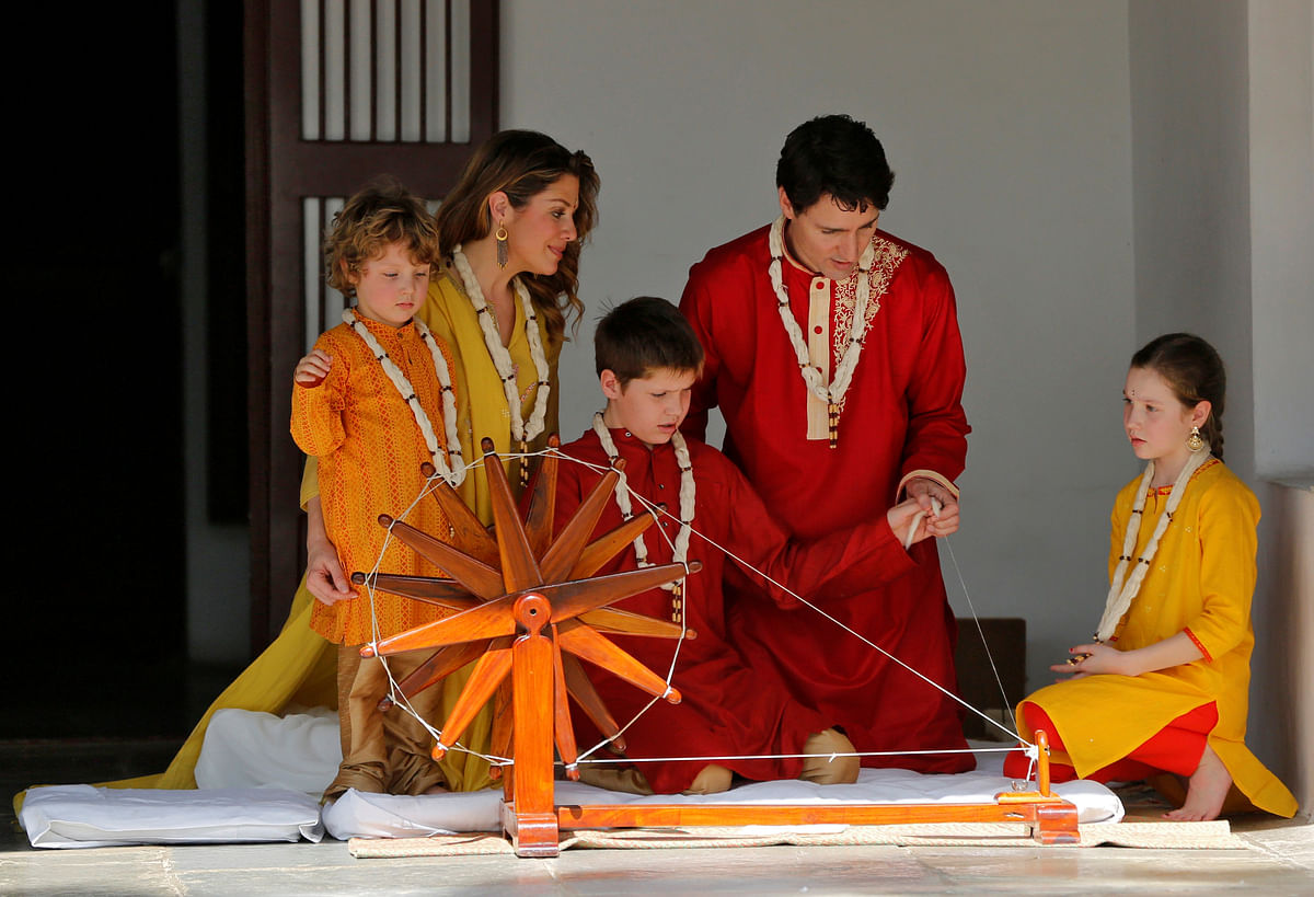 Canadian Prime Minister Justin Trudeau and his son Xavier spin cotton on a wheel watched by Trudeau`s wife Sophie Gregoire Trudeau, their daughter Ella Grace and son Hadrien during their visit to Gandhi Ashram in Ahmedabad, India on 19 February. Photo: Reuters