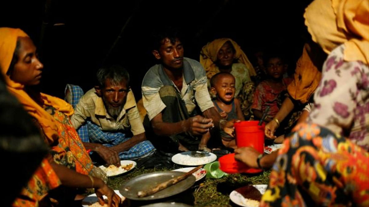 New Rohingya refugees bring their belongings as they build makeshift shelter in Gundum near Cox`s Bazar, on 3 September 2017. -- Reuters