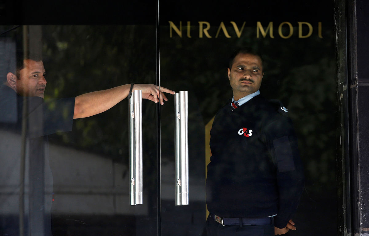 A security guard stands guard inside a Nirav Modi showroom during a raid by Enforcement Directorate, a government agency that fights financial crime, in New Delhi. Photo: Reuters