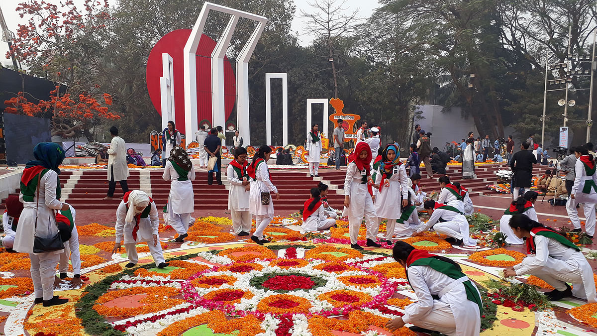 Students decorating the Central Shaheed Minar with flowers in Dhaka in observance of International Mother Language Day on 21 February. Photo: Hasan Raja