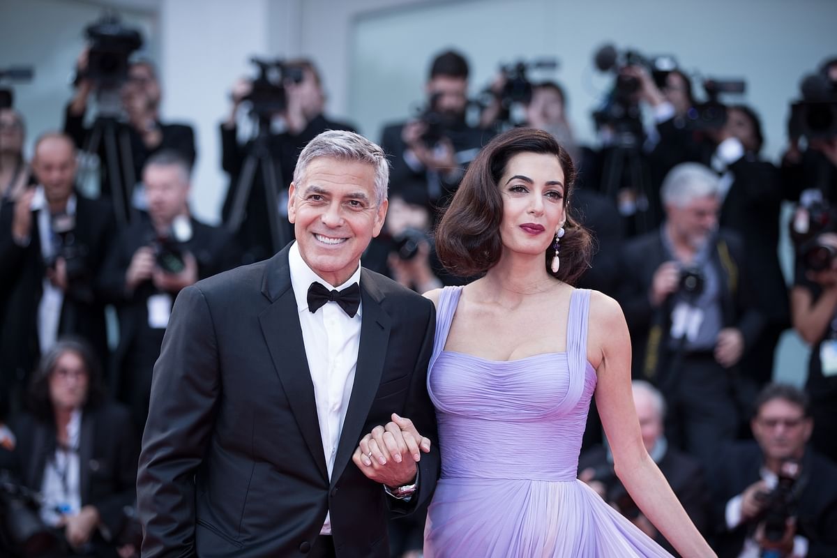 Director George Clooney (L) and his wife Amal attend the premiere of the movie `Suburbicon` in competition at the 74th Venice Film Festival in Venice, Italy on 2 September. Photo: IANS