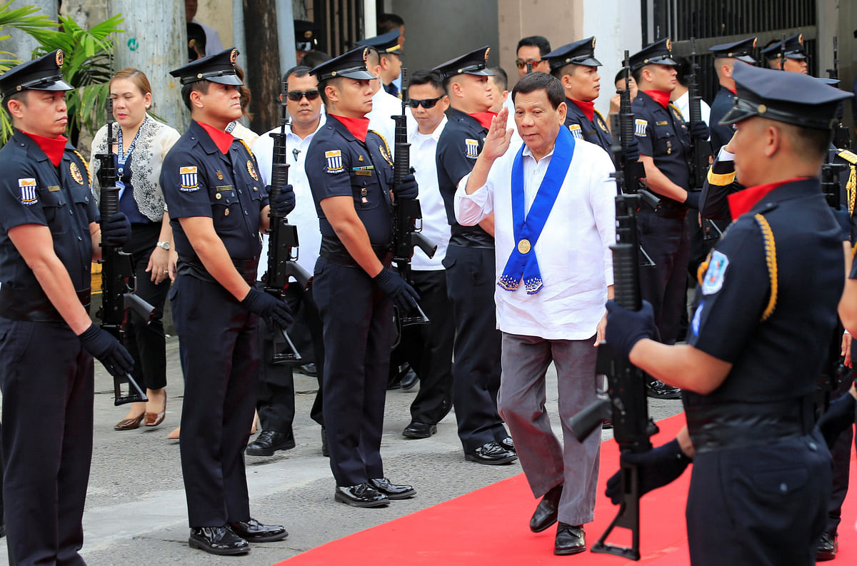 President Rodrigo Duterte salutes while passing members of custom police, upon arrival to witness the destruction of condemned smuggled luxury cars worth 61,626,000.00 pesos (approximately US$1.2 million), in Metro Manila. Photo: Reuters