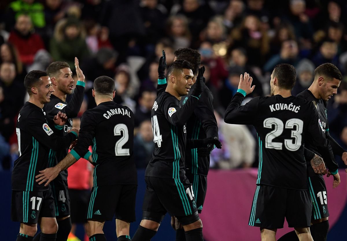 Real Madrid’s Brazilian midfielder Casemiro © celebrate with teammates after scoring during the Spanish league football match Club Deportivo Leganes SAD against Real Madrid CF at the Estadio Municipal Butarque in Leganes on the outskirts of Madrid on Wednesday. Photo: AFP