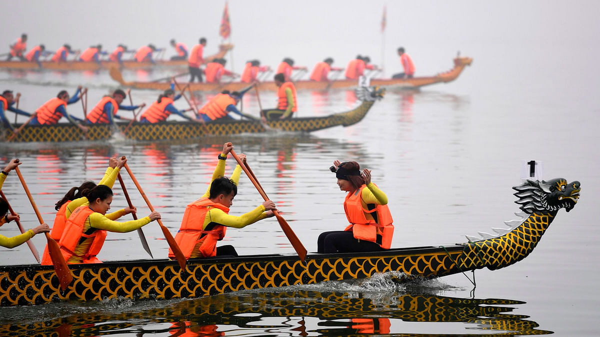 Rowers take part in a dragon boat race in Hanoi on Saturday. Photo: AFP