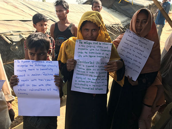 Rohingya women stand in line displaying their demands at Balukhali camp recently. Photo: Abu Taib Ahmed