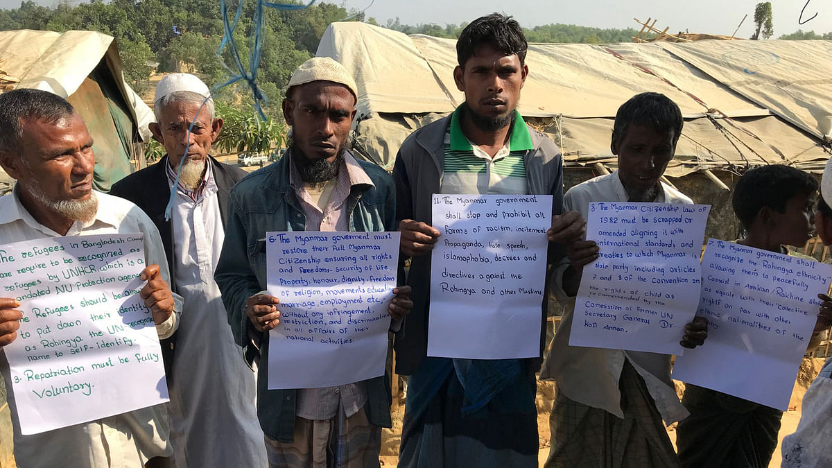 Rohingyas stand in queue displaying their demands at Balukhali camp recently. Photo: Abu Taib Ahmed