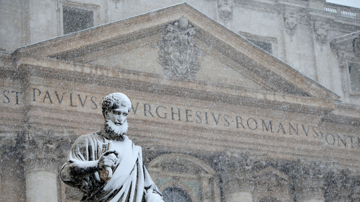 The statue of Saint Peter is pictured during a heavy snowfall in Saint Peter`s Square at the Vatican on 26 February. Photo: Reuters