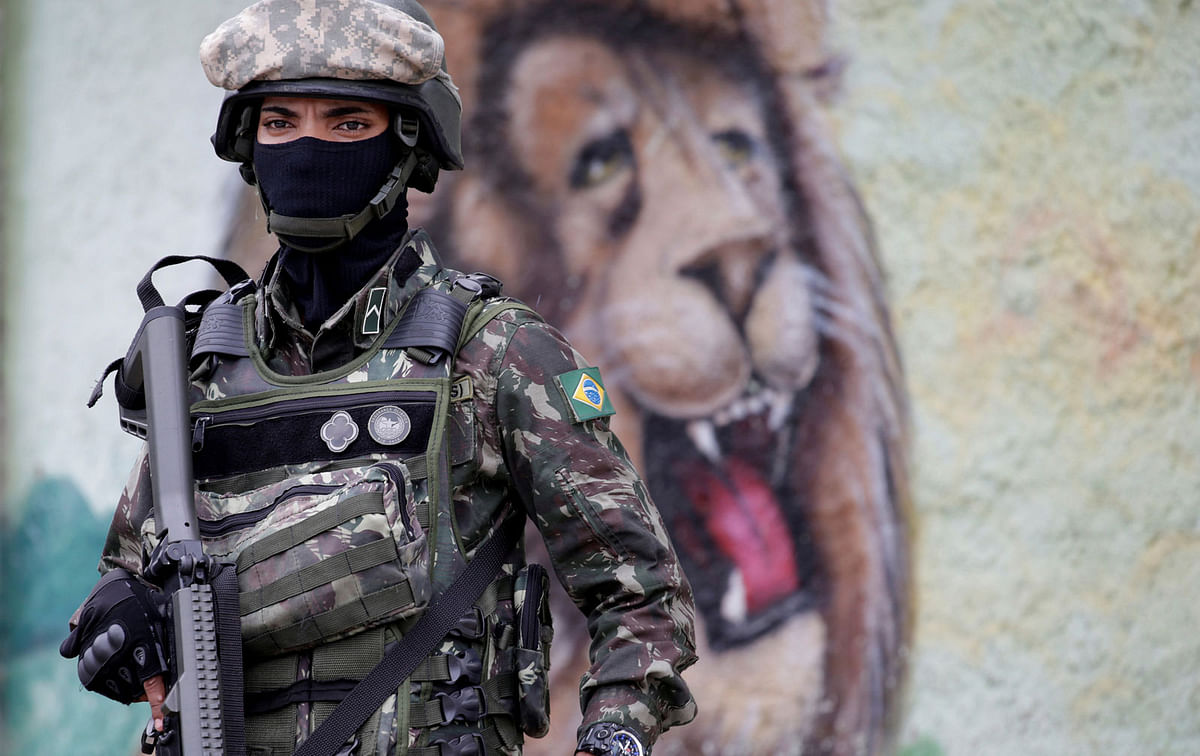 An armed forces member patrols during an operation against drug dealers in Vila Alianca slum, in Rio de Janeiro, Brazil on 27 February. Photo: Reuters