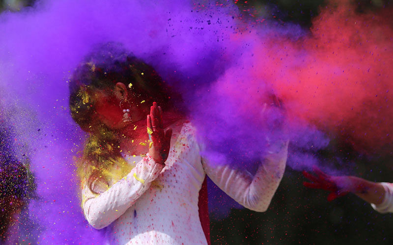 Indian college girls throw coloured powder to one another during Holi festival celebrations in Bhopal on 28 February. Photo: AFP