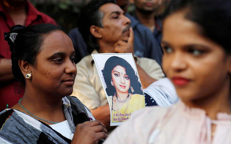 Fans of of Bollywood actress Sridevi hold her portrait as they wait to offer their condolences outside a makeshift memorial in Mumbai, India on 28 February. Photo: Reuters