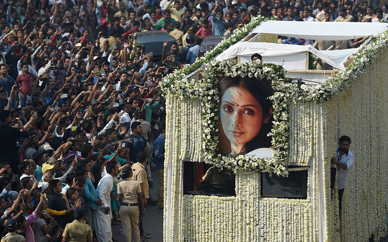 Indian fans watch as the funeral cortege of the late Bollywood actress Sridevi Kapoor passes through Mumbai on 28 February 2018. Photo: AFP