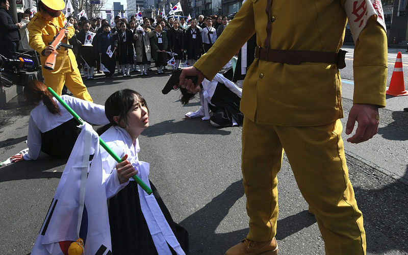 Activists dressed as colonial-era Japanese soldiers re-enact a crackdown of the independence movement during celebrations of the 99th Independence Movement Day against the 1910-1945 Japanese colonial rule in Seoul on 1 March. Photo: AFP