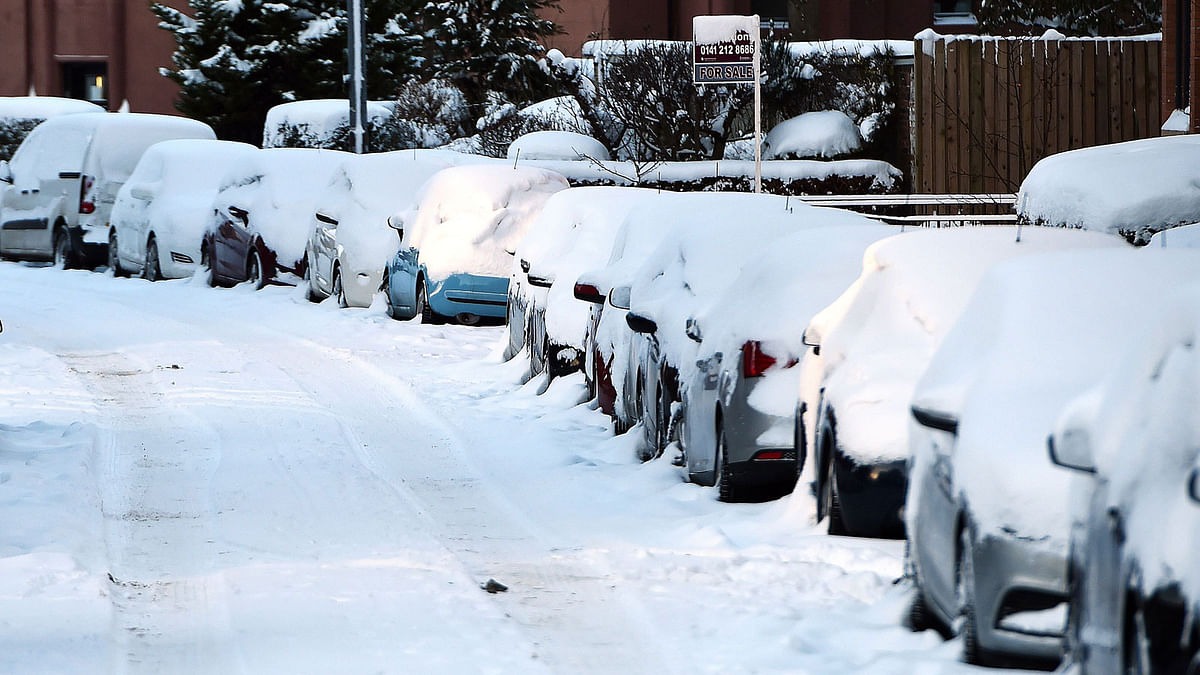 Cars are covered with snow in Glasgow after snow covered the city on 1 March 2018. Photo: AFP