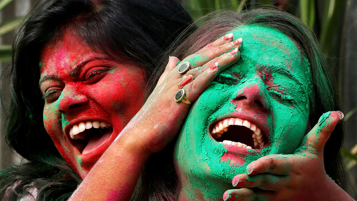 A college student smears a friend with coloured powder during Holi celebrations in Agartala, India on 1 March. Photo: Reuters