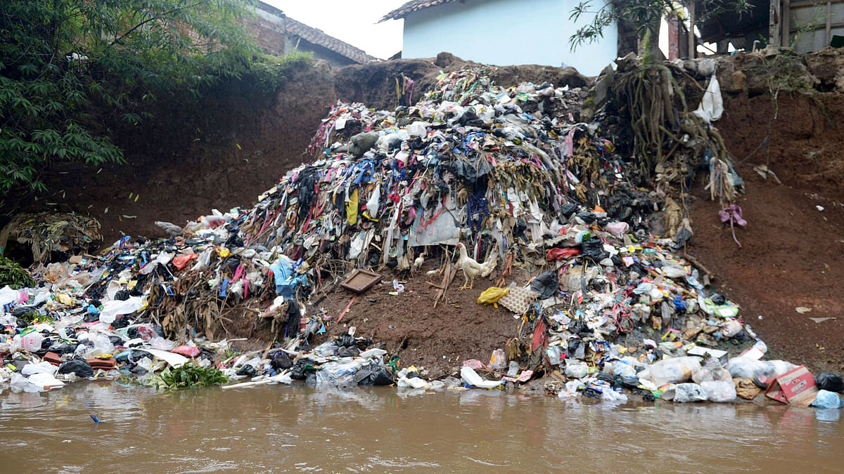 This picture taken on 5 February 2018 shows waste from houses dumped into the Citarum river in Majalaya, West Java. AFP