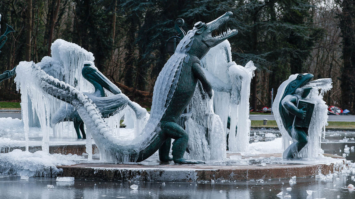 The sculpture `Le Bandundu Water Jazz Band` by Belgian artist Tom Frantzen is seen covered with ice in Tervuren, near Brussels, Belgium on 1 March. Photo: Reuters