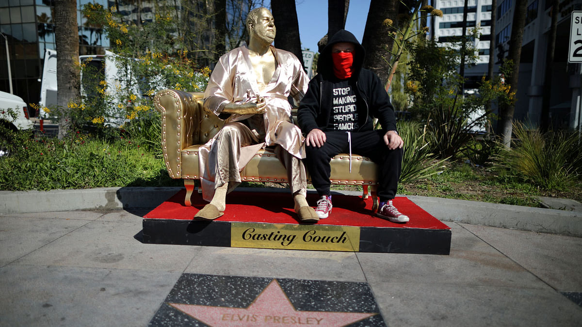 Artist Plastic Jesus sits on his statue of Harvey Weinstein on a casting couch on Hollywood Boulevard near the Dolby Theatre during preparations for the Oscars in Hollywood, Los Angeles, California, US on 1 March 1.Photo: Reuters