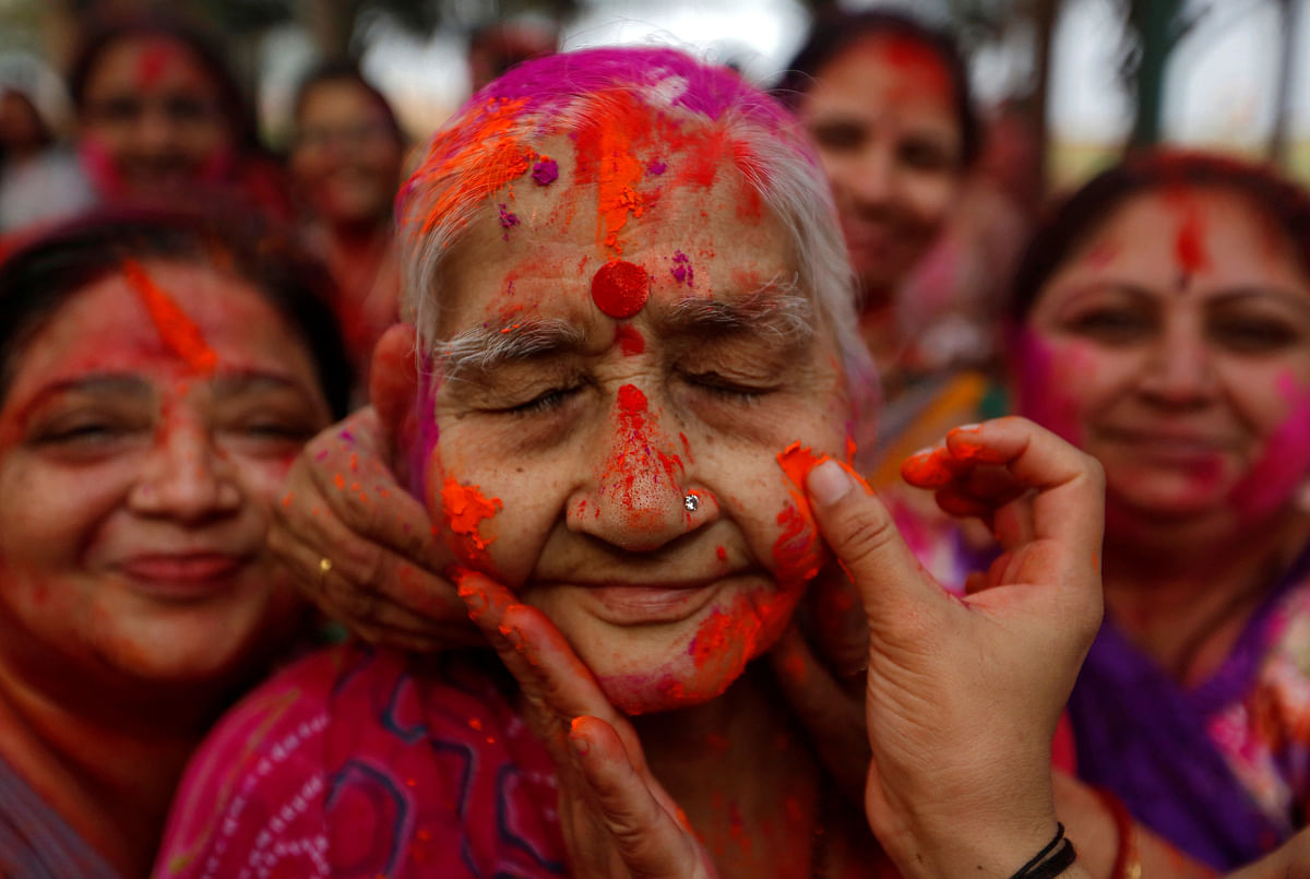 An elderly woman reacts as coloured powder is applied on her face duringHoli celebrations in Mumbai, India on 2 March. Photo: Reuters