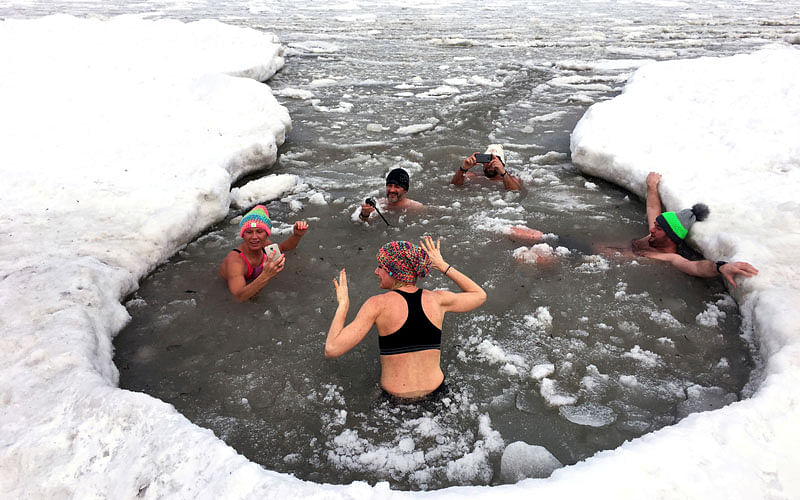 People take a bath in partly frozen Baltic sea in Sopot, Poland on 3 March. Photo: Reuters