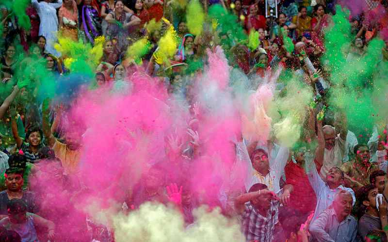 Hindu devotees throw colour powder at each other inside a temple premises during celebrations for Holi in Ahmedabad, India on 3 March. Photo: Reuters