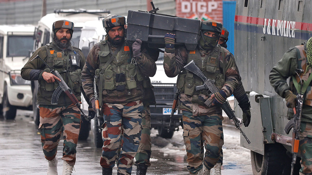 Indian army soldiers carry a box containing bulletproof shields near the site of a gunbattle with suspected militants in Srinagar 12 February, 2018. Photo: Reuters