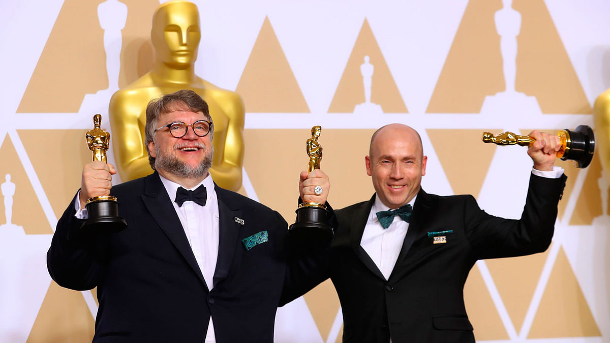 Guillermo del Toro and J. Miles Dale after winning Best Picture and Best Director awards for `The Shape of Water.` Photo: Reuters