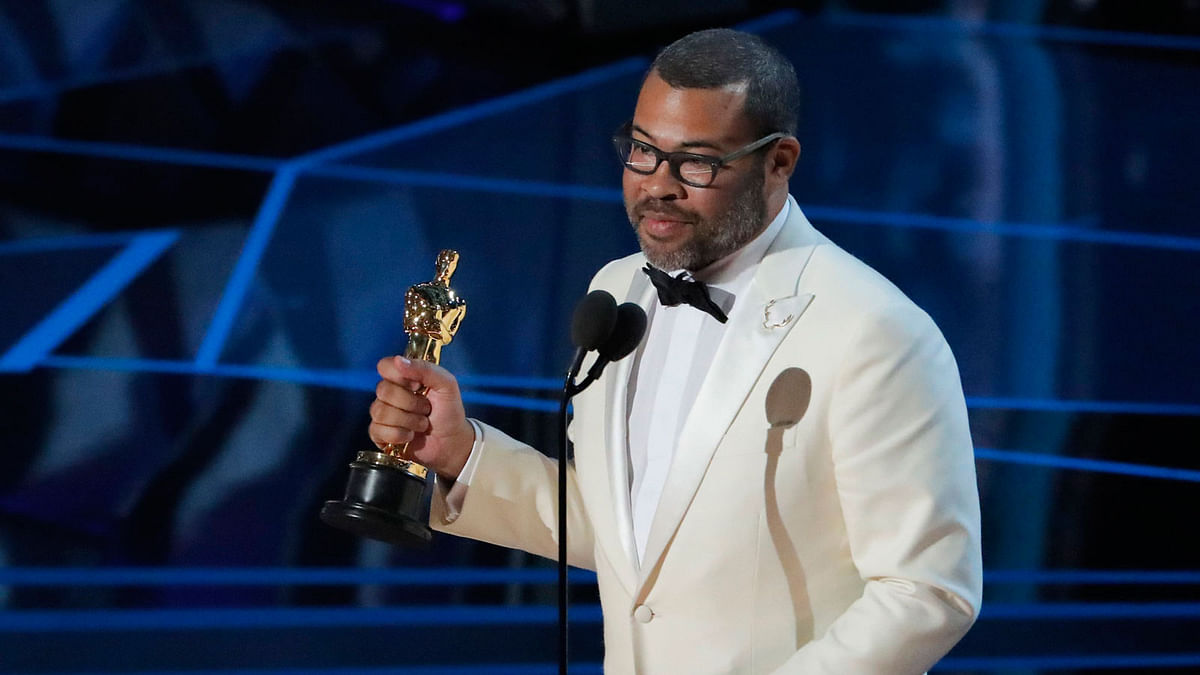 Jordan Peele accepts the Oscar for Best Original Screenplay for `Get Out.` Photo: Reuters