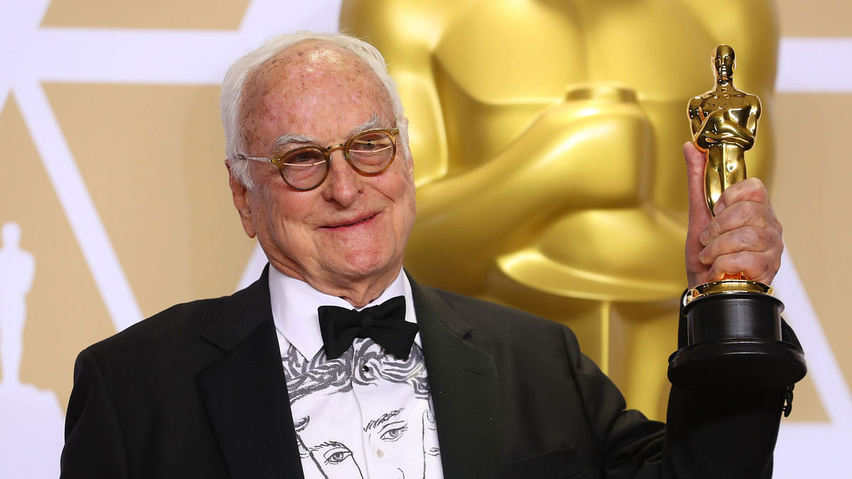 James Ivory wears a shirt depicting actor Timothee Chalamet as he holds his Oscar for Best Adapted Screenplay for `Call Me My Your Name.` Photo: Reuters