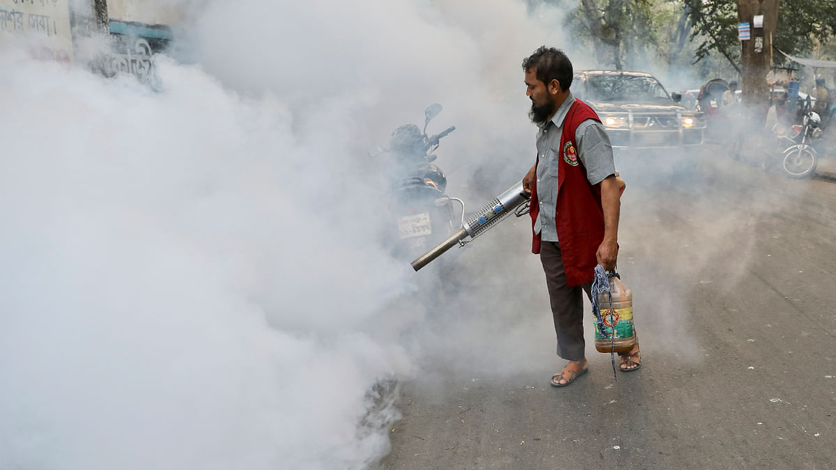 A DNCC worker sprays aerosol in Dhanmondi-11 as part of the Dhaka North City Corporation`s anti-mosquito drive on 6 March. Photo: Tanvir Ahmed