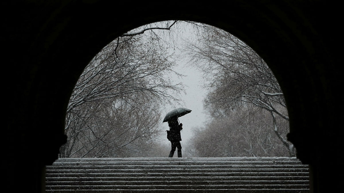 A pedestrian walks through Central Park during a snow storm in New York, US on 7 March. Reuters
