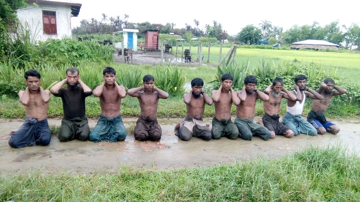 Ten Rohingya Muslim men with their hands bound kneel in Inn Din village. Picture taken 1 September 2017. Reuters