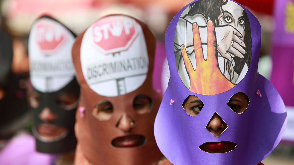 Women, wearing masks on their faces, take part in a rally celebrating International Women`s Day in the National Press Club area in Dhaka on 8 March. Photo: Suvra Kanti Das