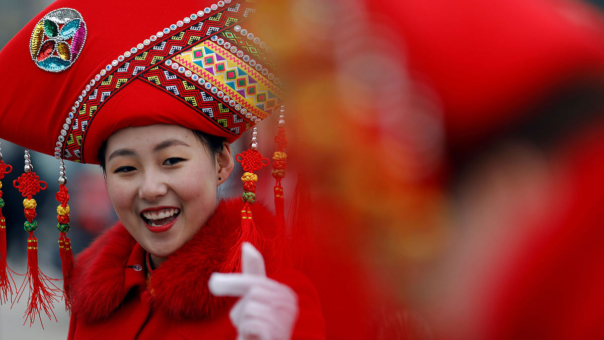 Ushers film themselves with mobile phone outside the Great Hall of the People during the third plenary session of the National People`s Congress (NPC) in Beijing, China on 11 March. Photo: Reuters
