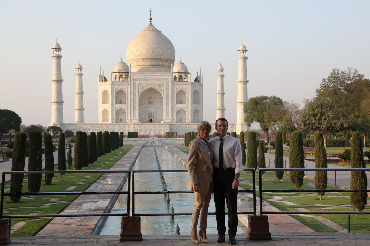 French President Emmanuel Macron and his wife Brigitte Macron pose for a photograph at the Taj Mahal in Agra, India on 11 March. Photo: Reuters