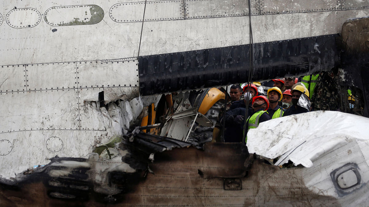 Rescue workers work at the wreckage of a US-Bangla airplane after it crashed at the Tribhuvan International Airport in Kathmandu, Nepal on 12 March. Photo: Reuters