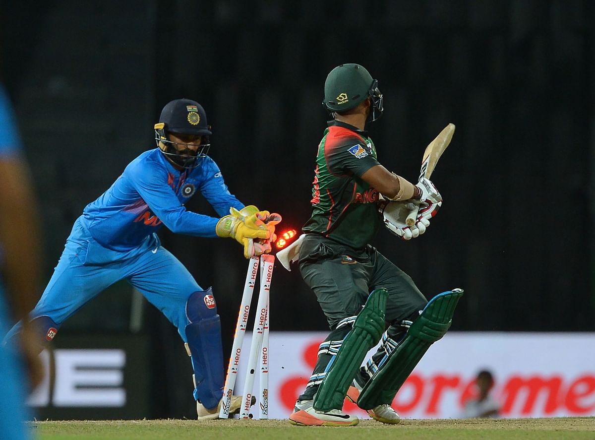 Indian wicketkeeper Dinesh Karthik (L) attempts to stump Bangladesh batsman Liton Das. AFP