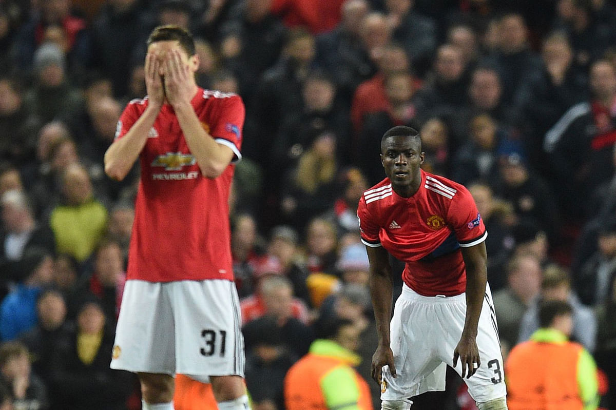 Manchester United’s Serbian midfielder Nemanja Matic (L) and Manchester United’s Ivorian defender Eric Bailly react after Sevilla scored their first goal during a last 16 second leg UEFA Champions League football match between Manchester United and Sevilla at Old Trafford in Manchester on Tuesday. Photo: AFP