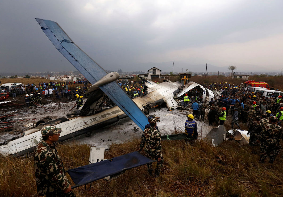Rescue workers work at the wreckage of a US-Bangla airplane after it crashed at the Tribhuvan International Airport in Kathmandu. Photo: Reuters