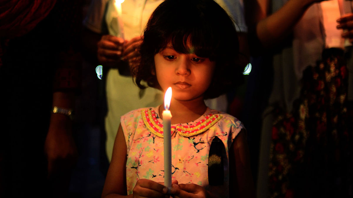 Members of Society of the Deaf and Sign Language Users (SDSL) and residents light candle during a vigil for SDSL founder Rafiq Zaman, his wife and son, who were killed in the US-Bangla plane crash in Kathmandu, in Dhaka on 25 March, 2018. Photo: AFP