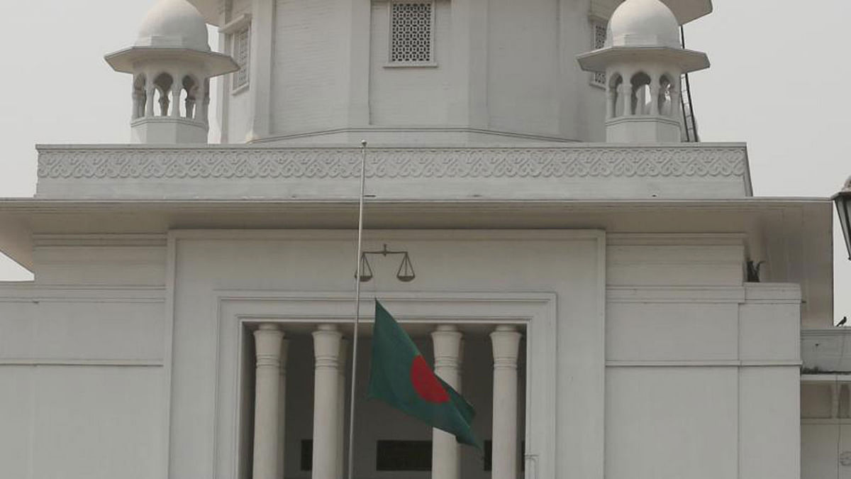The national flag is kept half-mast at the High Court premises in Dhaka on Thursday in memory of the victims of the US-Bangla plane crash in Kathmandu, Nepal. Bangladesh observes state mourning day on Thursday commemorating the incident. Photo: Hasan Raja