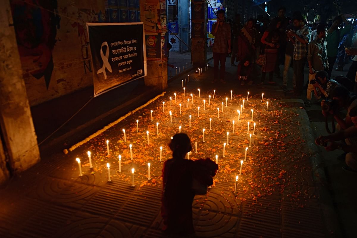 Bangladeshi people take part in a candlelight vigil in honour of victims of a US-Bangla Airlines plane crash. AFP file photo