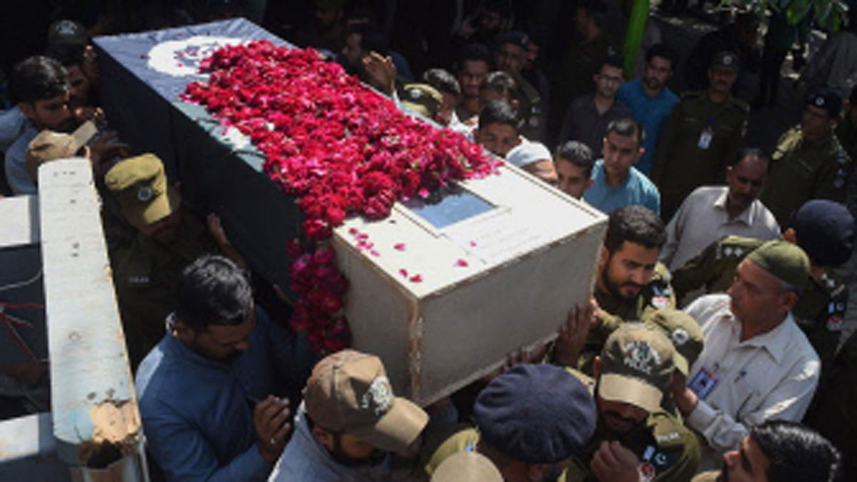Pakistani policemen carry the coffin of a colleague during their funeral ceremony in Lahore on March 15, 2018, following an overnight suicide attack