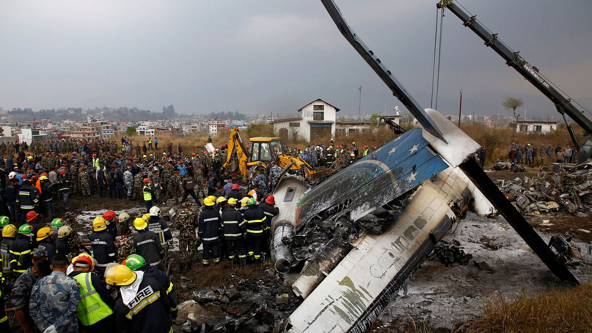 Rescue workers work at the wreckage of a US-Bangla airplane after it crashed at the Tribhuvan International Airport in Kathmandu, Nepal 12 March, 2018. Photo: Reuters
