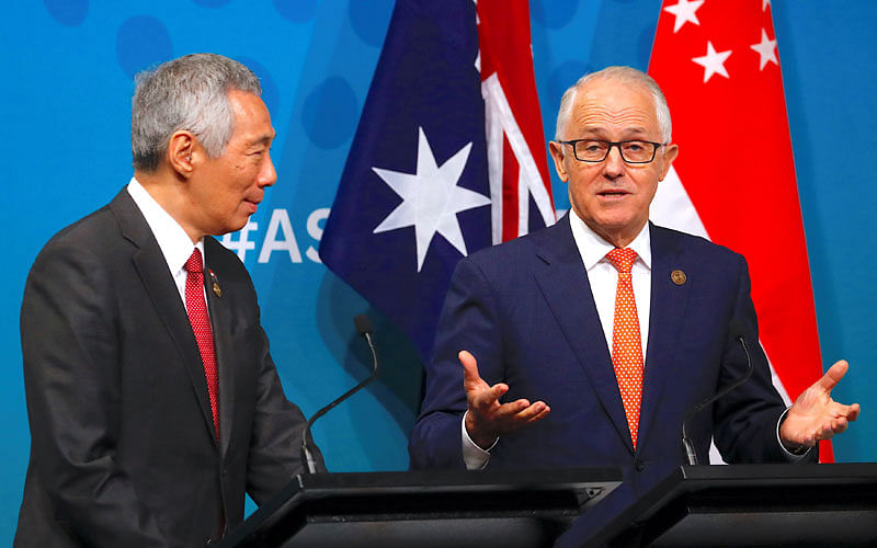 Australian prime minister Malcolm Turnbull walks behind prime minister of Singapore Lee Hsien Loong talk during their media conference during the one-off summit of 10-member Association of Southeast Asian Nations (ASEAN) in Sydney, Australia, on 16 March 2018. Reuters