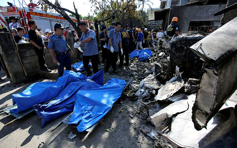 Rescuers recover dead bodies after a small plane crashed into a house, in Plaridel town, Bulacan province, Philippines on 17 March 2018. Photo: Reuters
