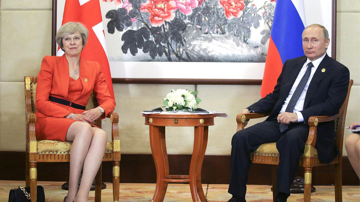 A file photo shows Vladimir Putin and Theresa May. Photo: Collected