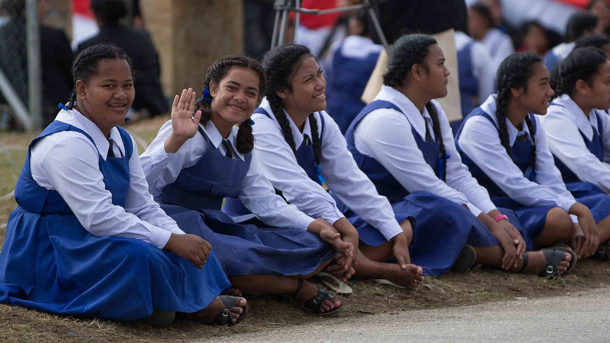 This photo shows Tongan girls wait for their king to arrive for his coronation ceremony in Nuku`. Tongan government has recently banned girls from participating in rugby and boxing. Photo: Collected