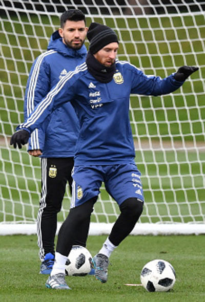 Argentina`s forward Sergio Aguero (L) watches Lionel Messi during a team training session at the City Academy training complex in Manchester, north west England on March 20, 2018 ahead of their March 23 international friendly football match against Italy at the Ethiad Stadium. AFP