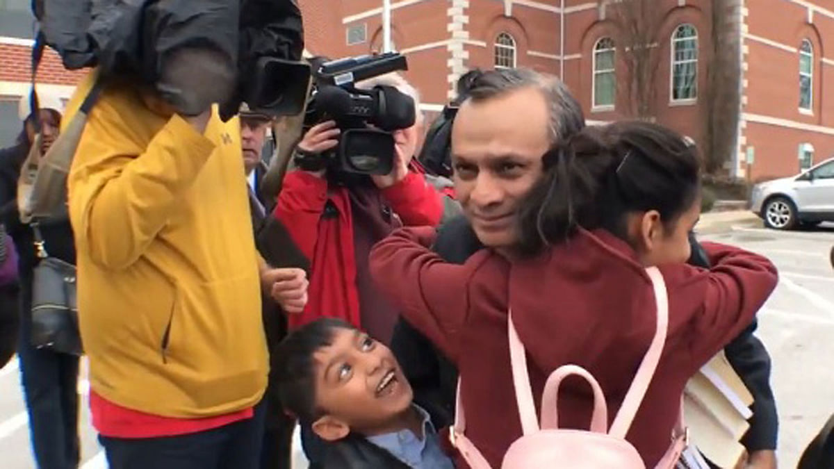 Syed A Jamal, a Bangladeshi-origin US chemist embraces his children. A screen-gran taken from a video on kansascity.